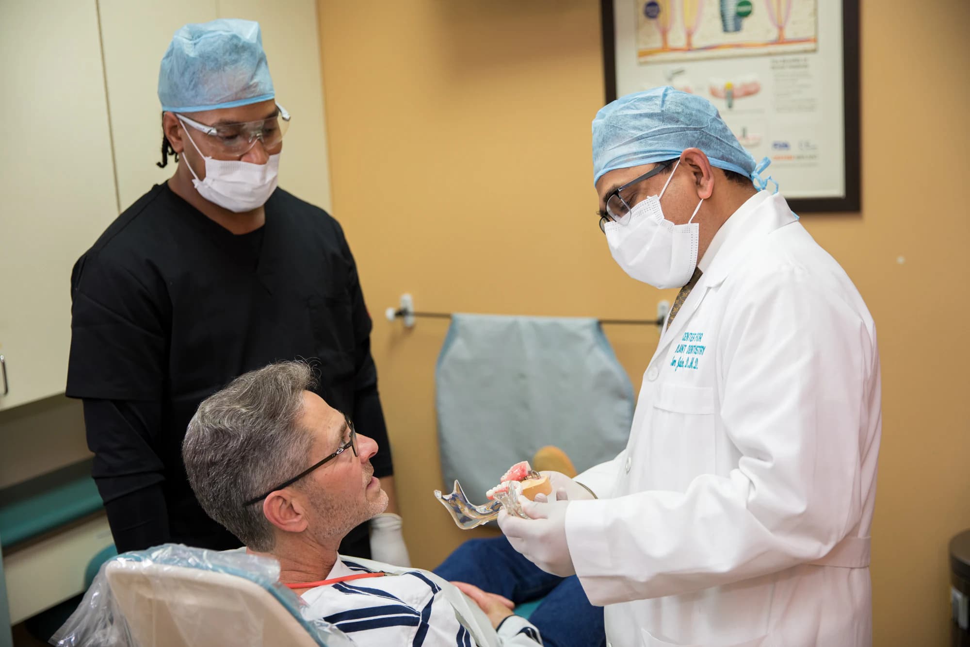 Implant dentist planning multiple tooth replacement chairside with a patient