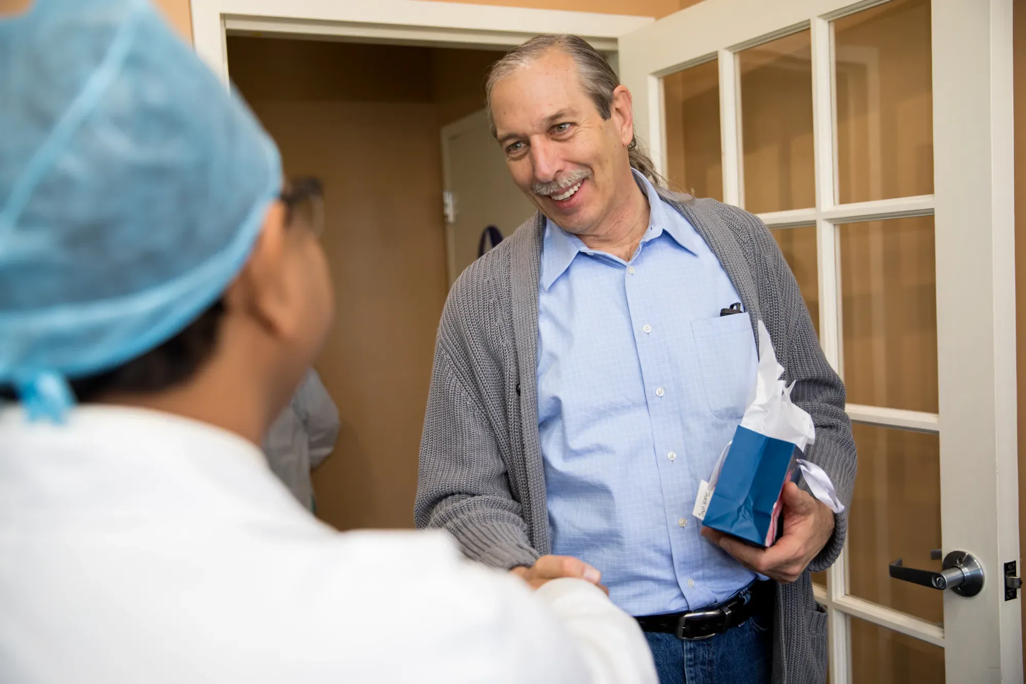Dr. Jain talking one-on-one with a patient about replacing a missing tooth