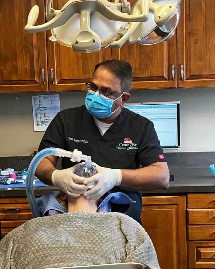 Dr. Jain overseeing IV sedation during implant treatment