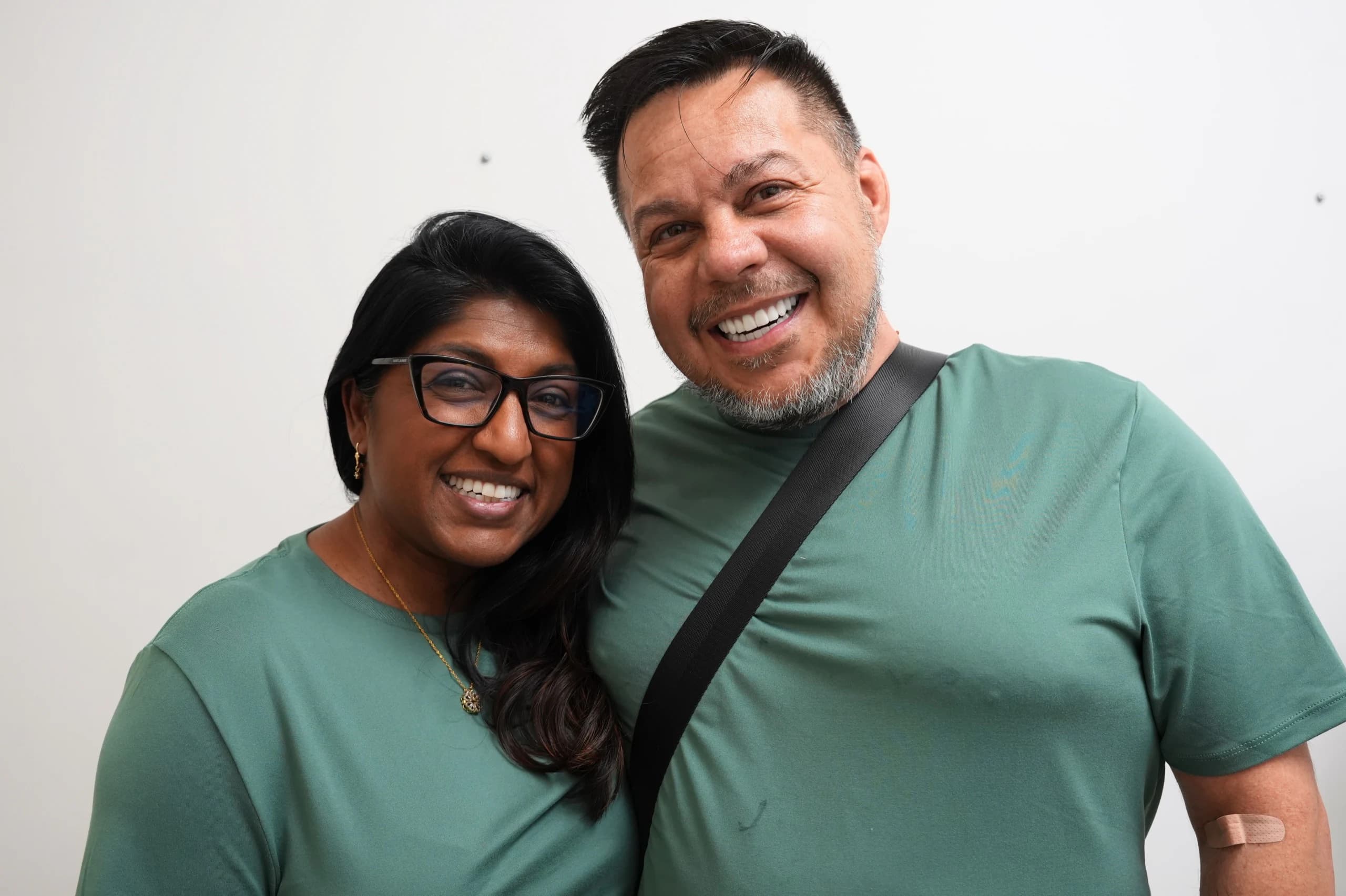 Couple smiling together after dental implant care at Center for Implant Dentistry
