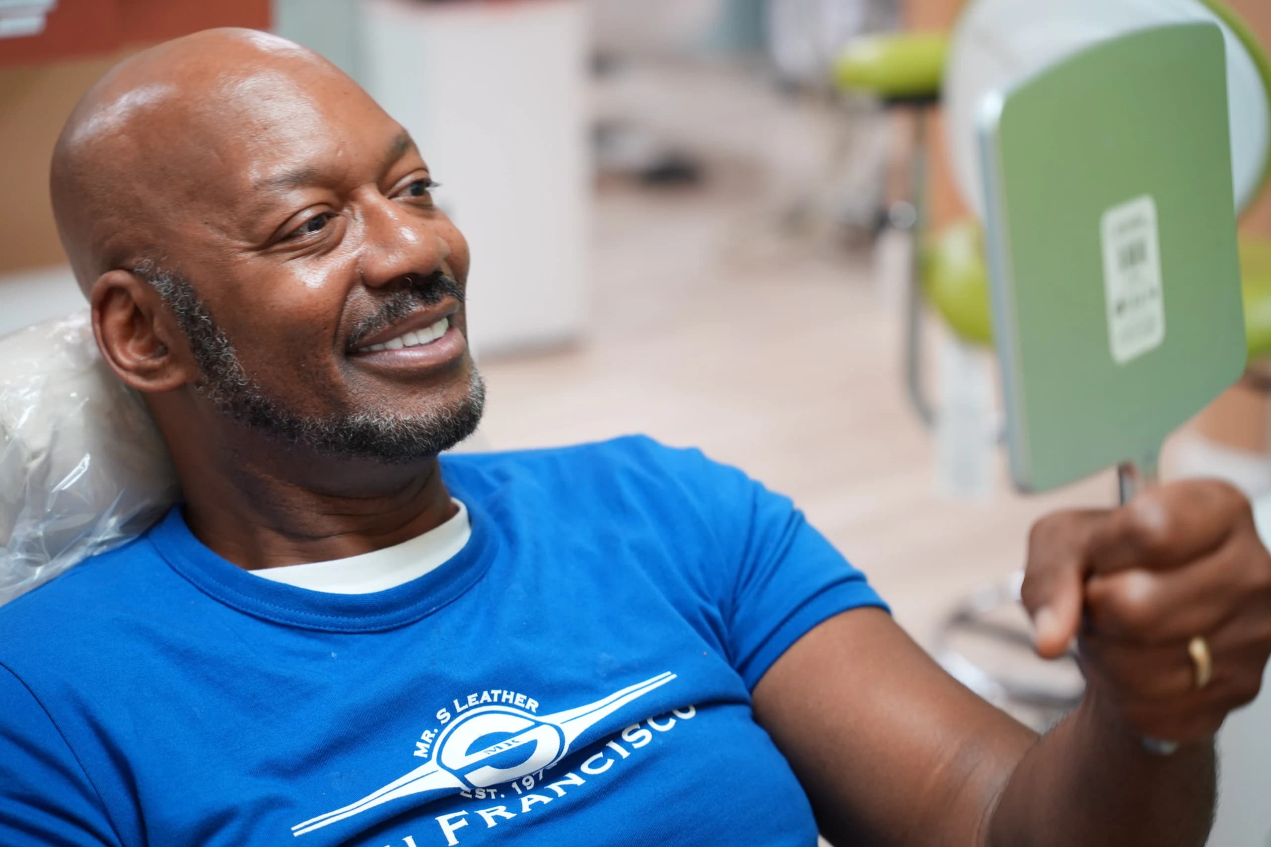 Former denture wearer smiling with fixed implant teeth