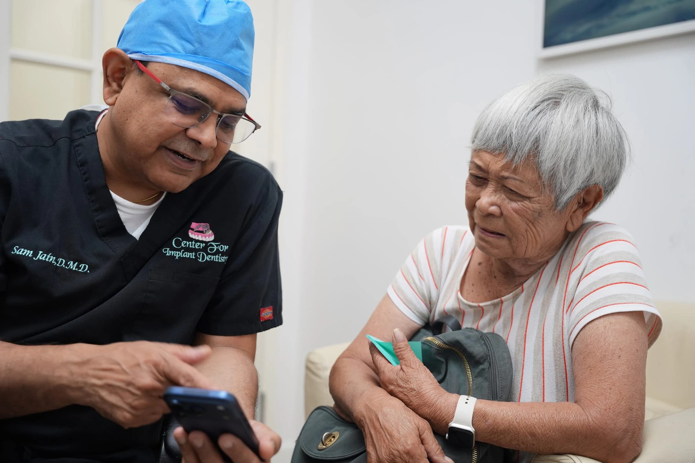 Dr. Sam Jain going through a treatment plan with a patient
