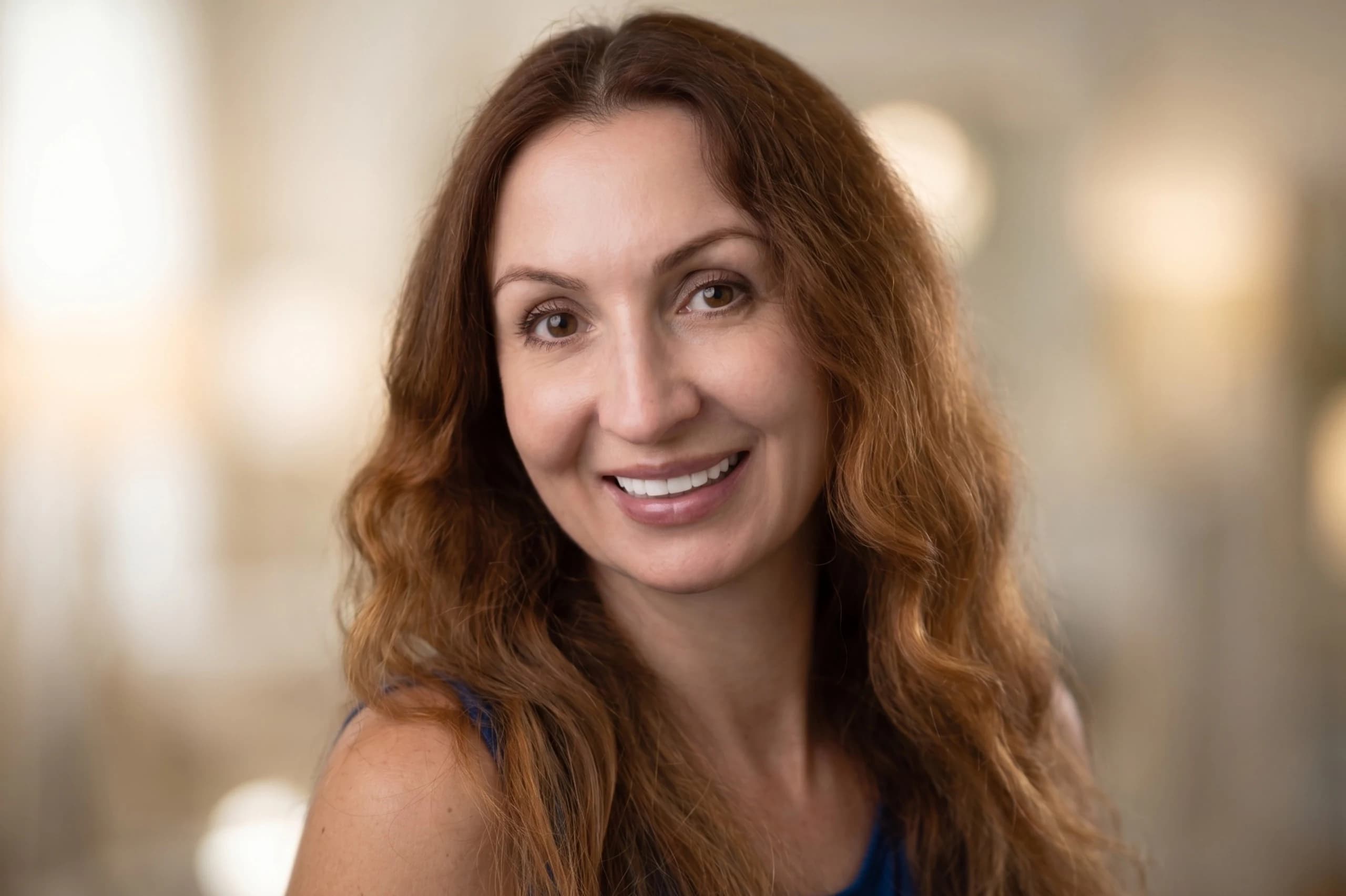 An implant patient smiling for her portrait