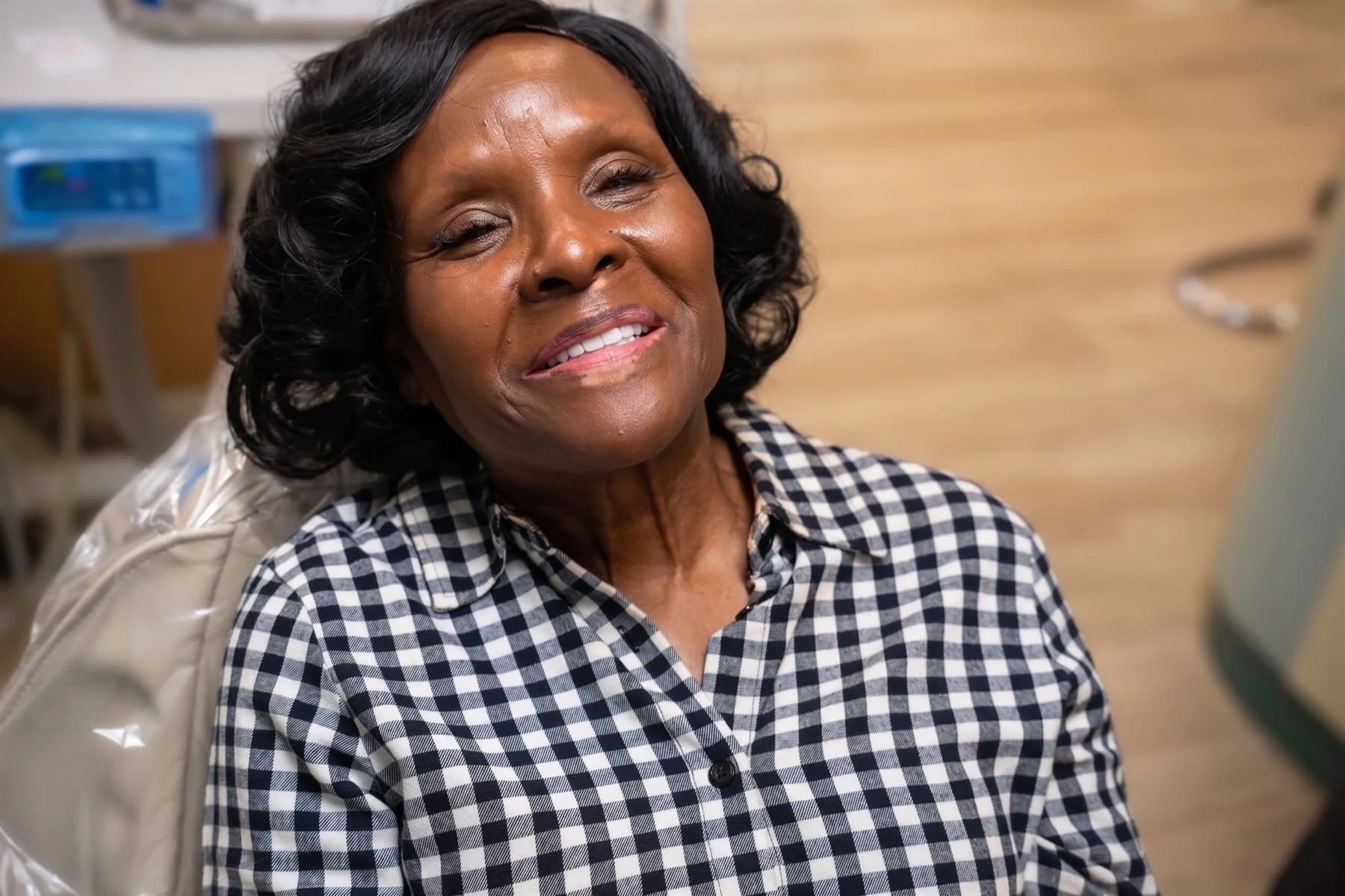 A patient smiling in the treatment chair