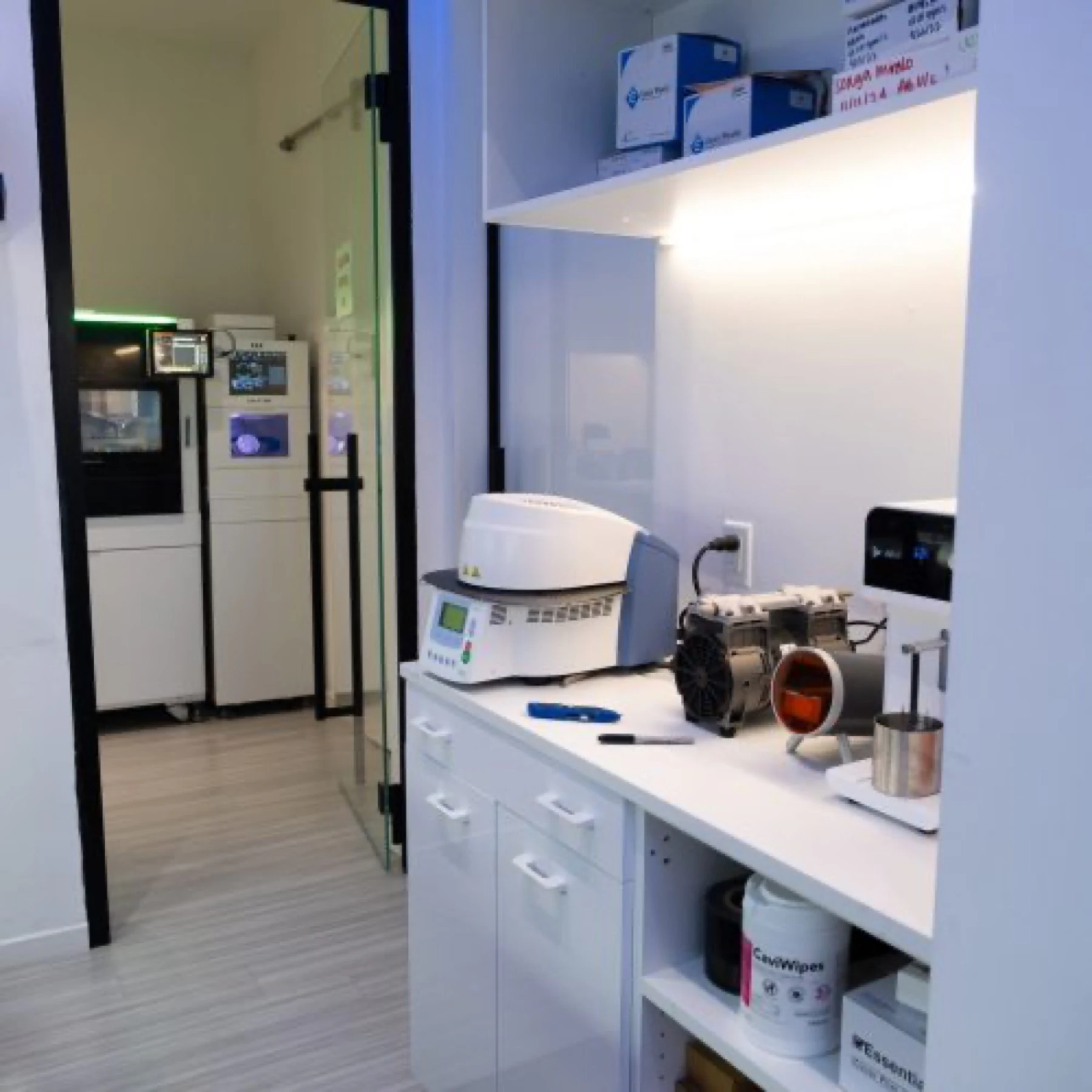 The sintering furnace and printers along the lab bench
